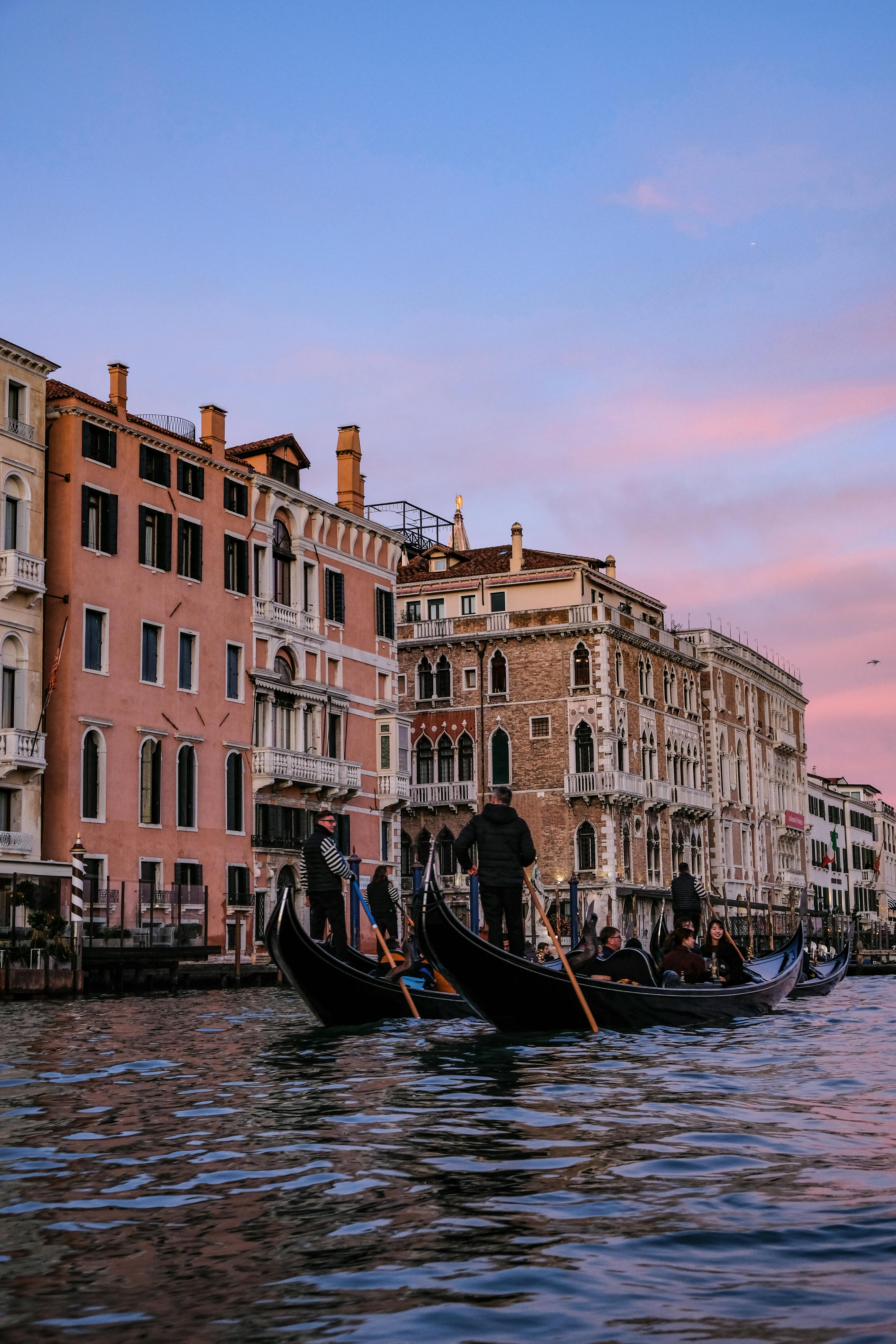 boat on river between buildings