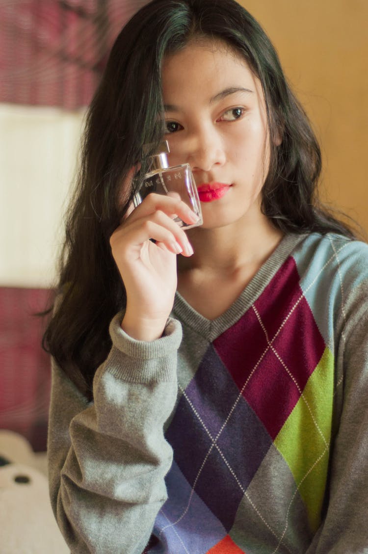 Crop Dreamy Asian Woman With Perfume At Home