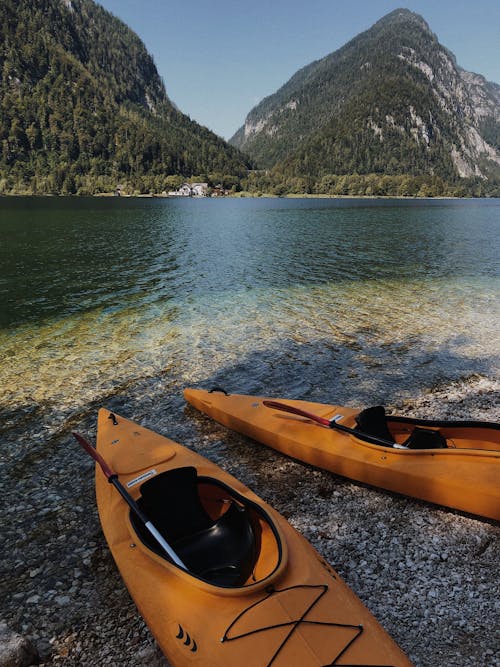 Yellow Kayaks on Shore Near Body of Water