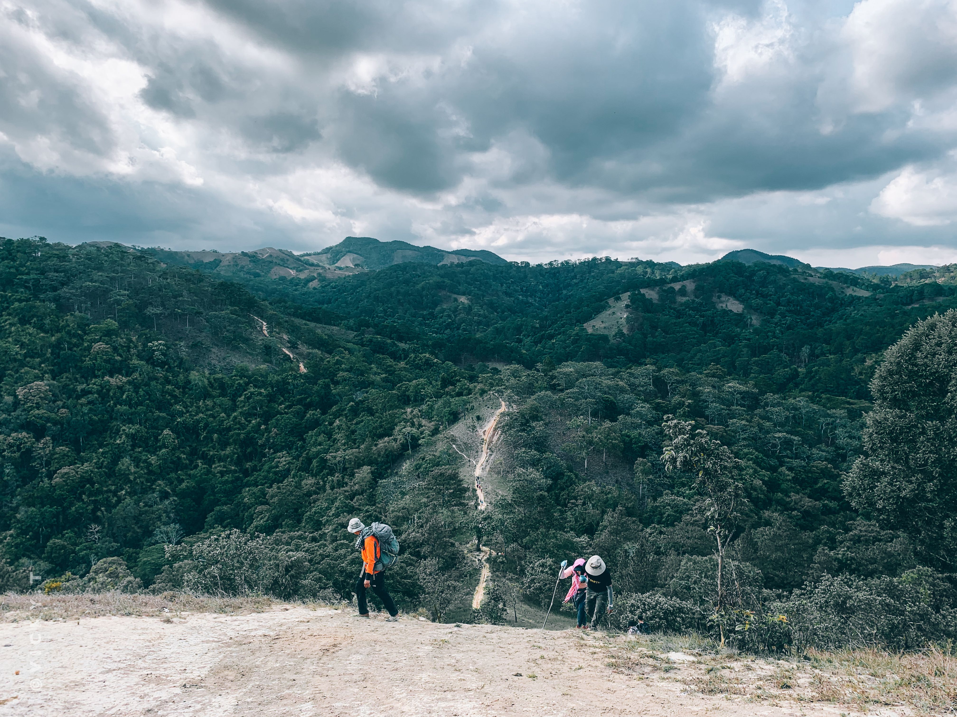 Stunning Expedition to the Arch and to the Lands End, with Snorkeling Beach. Review: Your Ultimate Cabo San Lucas Adventure Guide Review 2026 - A scenic view of hikers traversing lush green hills under a dramatic sky, offering a glimpse into nature's beauty.