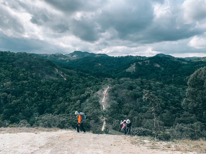 Stunning Expedition to the Arch and to the Lands End, with Snorkeling Beach. Review: Your Ultimate Cabo San Lucas Adventure Guide Review 2026 - A scenic view of hikers traversing lush green hills under a dramatic sky, offering a glimpse into nature's beauty.