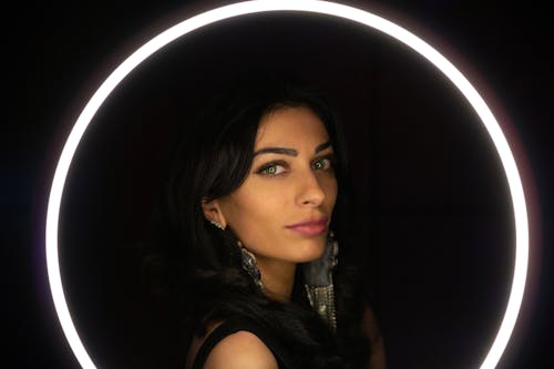 Woman Posing Beside a Ring Light