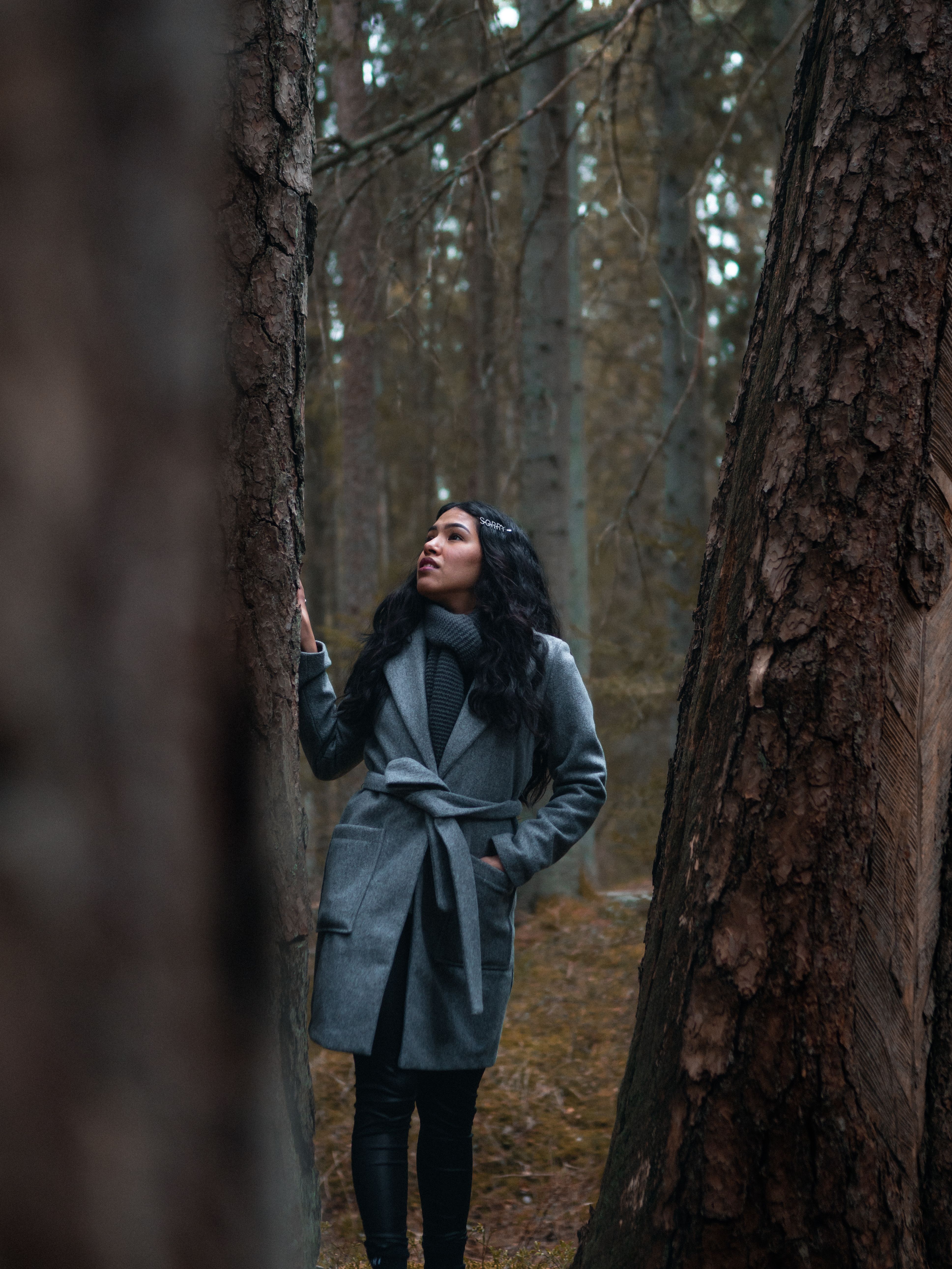 Woman in Gray Coat Standing Beside a Tree · Free Stock Photo