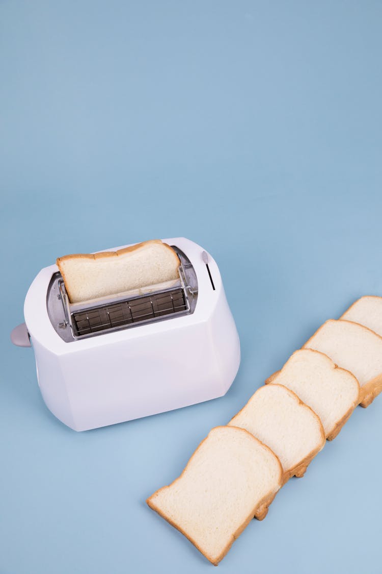 Cut Bread Placed On Table With Toaster