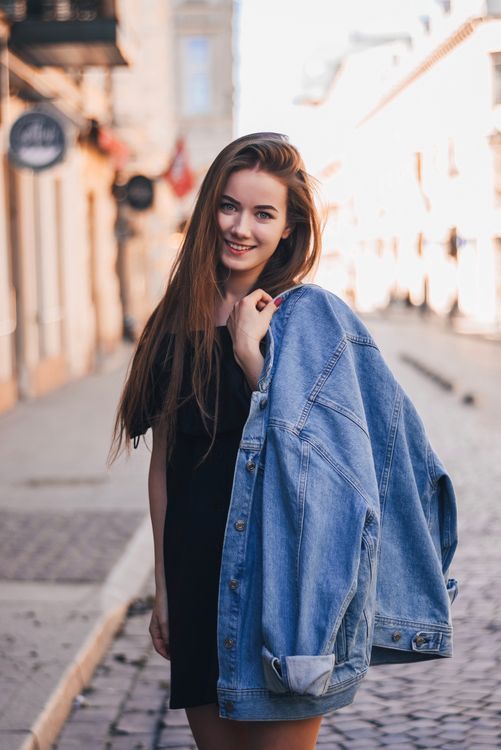 Cheerful woman with long hair on street · Free Stock Photo