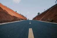 Black Asphalt Road Between Brown Mountains