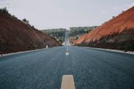 Gray Asphalt Road Between Brown Mountains