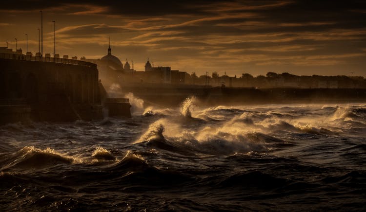 Stormy Sea Waving On Embankment Of Old City