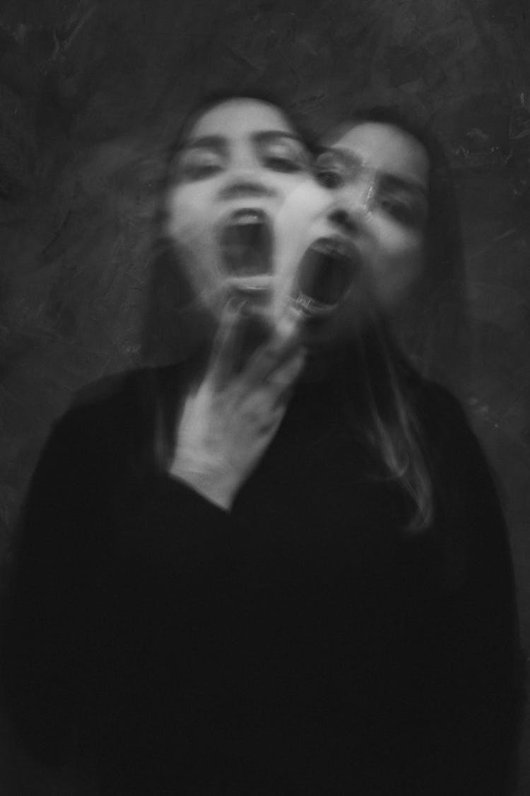 Grayscale Photo Of A Woman In Black Long Sleeve Shirt With Mouth Open Wide