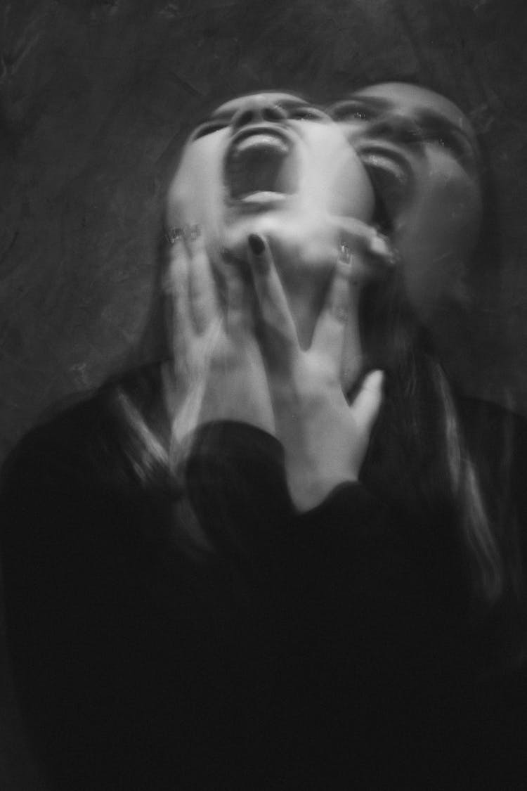 Grayscale Photo Of A Woman In Black Long Sleeve Shirt Screaming
