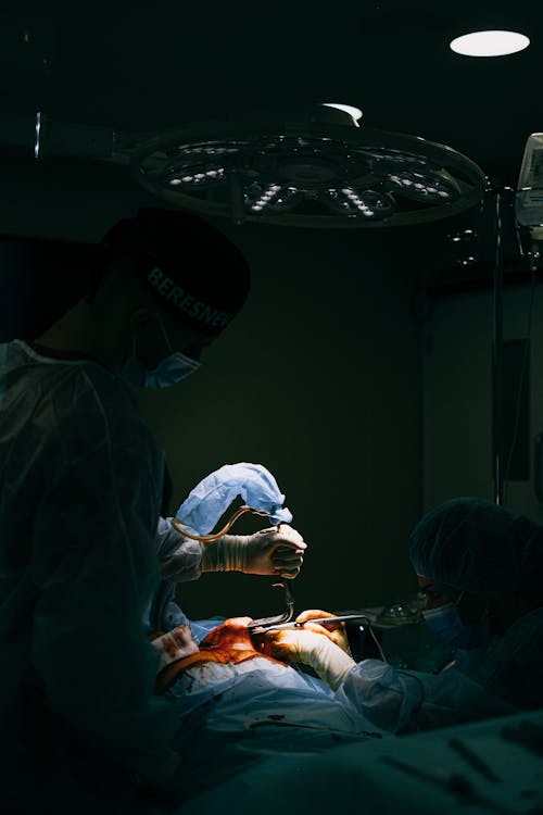 Free A Surgeon Operating a Patient in the Operating Room Stock Photo