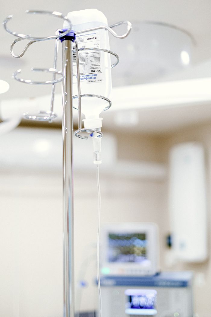 A close view of an intravenous drip in a sterile clinical setting