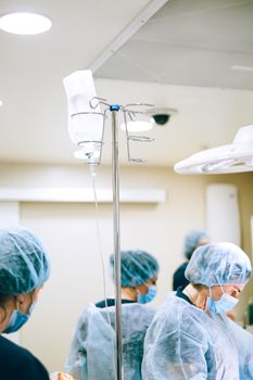 Healthcare professionals wearing protective gear in a hospital environment.