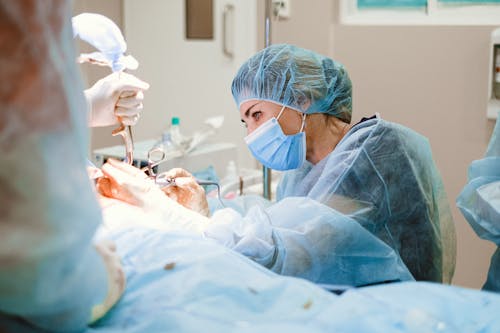 Free Woman Doing a Surgery on a Patient Stock Photo