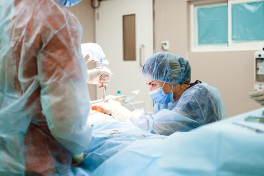 Female surgeon performing a surgical procedure in an operating room with sterile equipment.