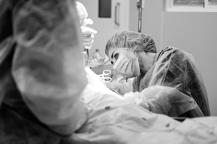 Grayscale Photo Of A Doctor Doing A Surgery