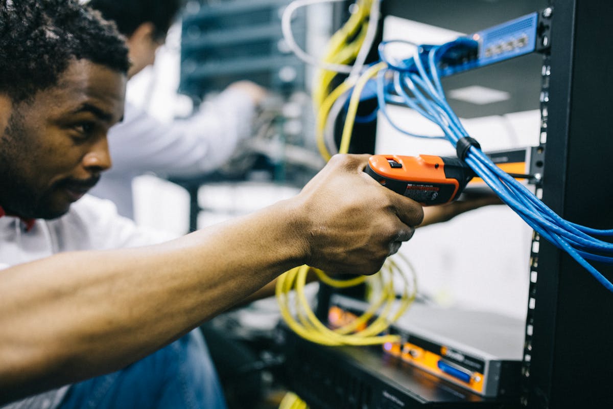 NexGen IT Solutions technician configuring a business network rack in Dallas