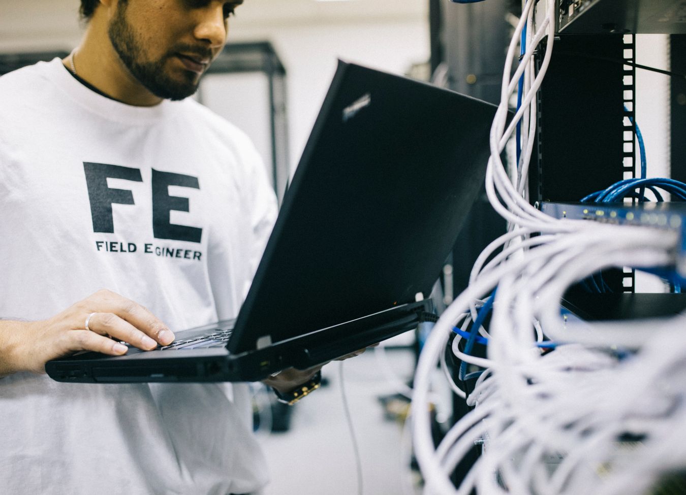 Technicians performing network equipment installation and troubleshooting at a client site