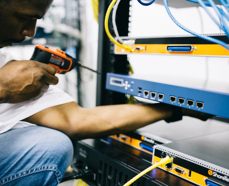 Field technician installing network equipment at a client site