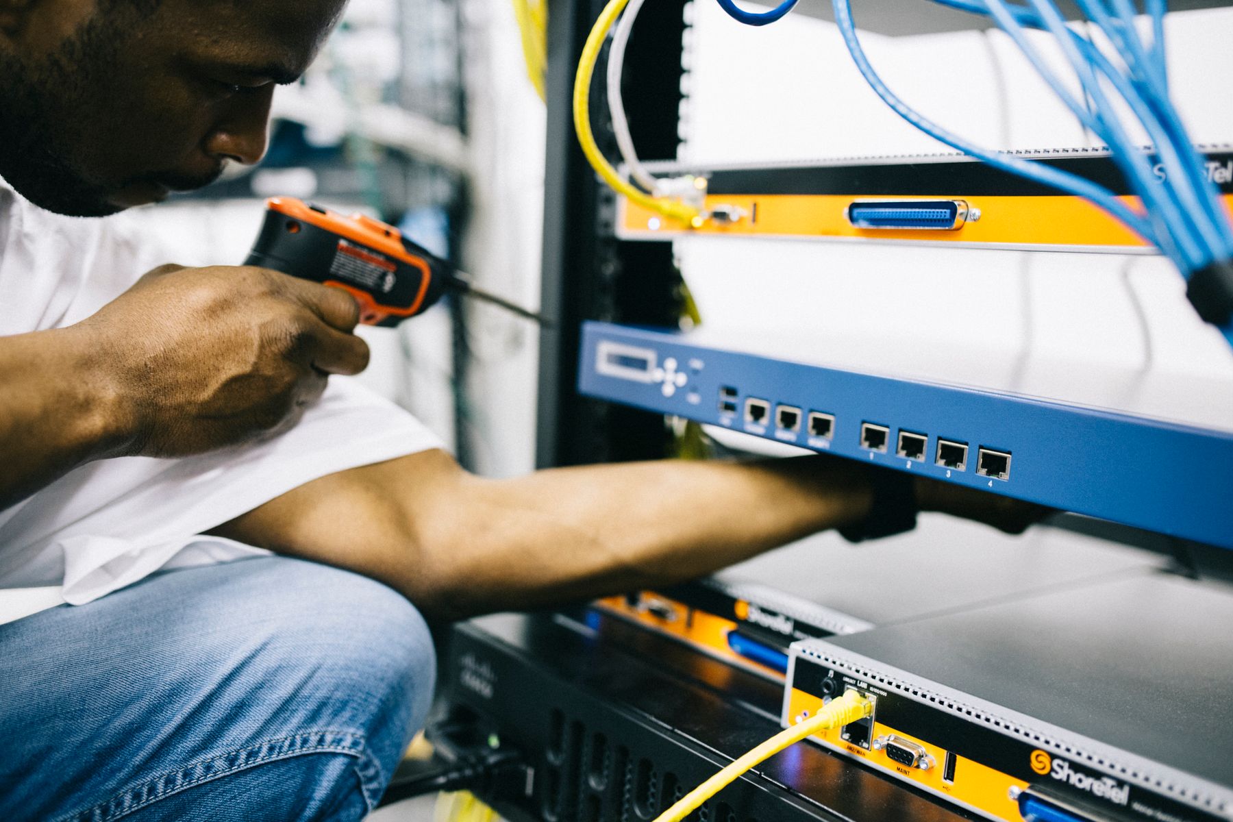 Technician maintaining hardware inside a data center