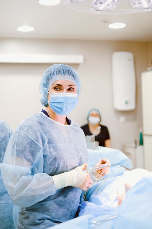 Free Doctor in Medical Gown Looking Away Stock Photo