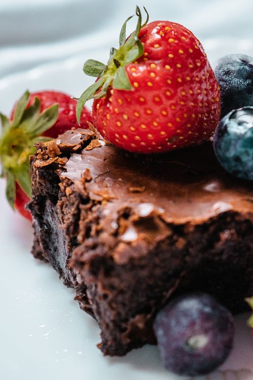 Free Closeup of yummy chocolate homemade piece of cake with fresh berries placed on white plate Stock Photo