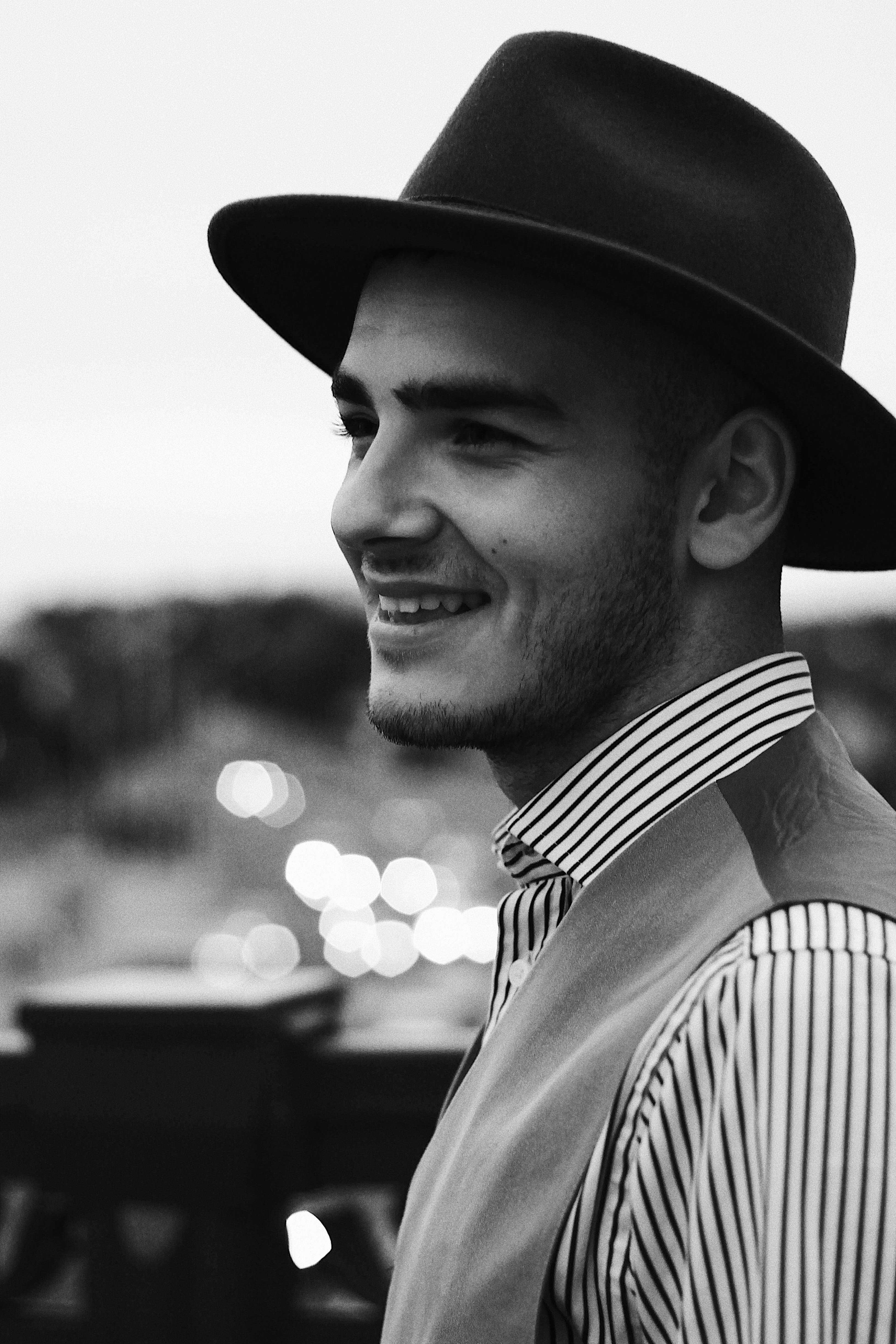 man in black hat smiling