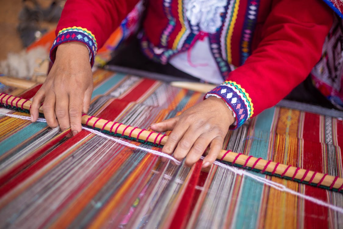 Person Weaving Colored Textile