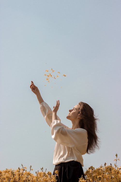 Free Woman Standing among Flowers, Throwing Flowers  Stock Photo