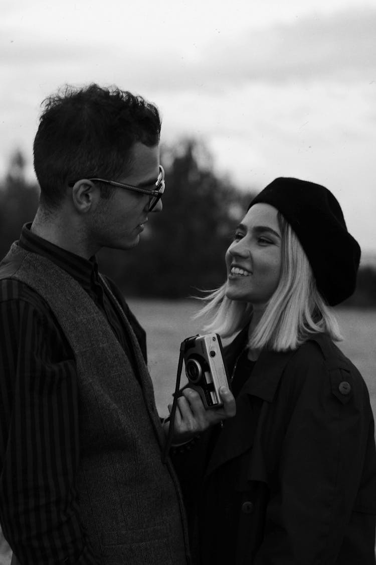 Grayscale Photo Of Man And Woman Smiling