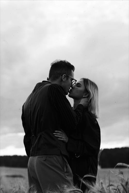 Grayscale Photo of Couple Kissing