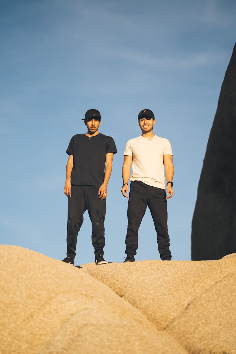 Positive Men Standing On Stony Hill