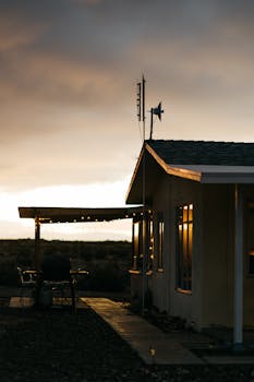Exterior of modern white village house located under cloudy sky in peaceful countryside