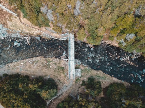 Drone view new bridge across brook in woodlands