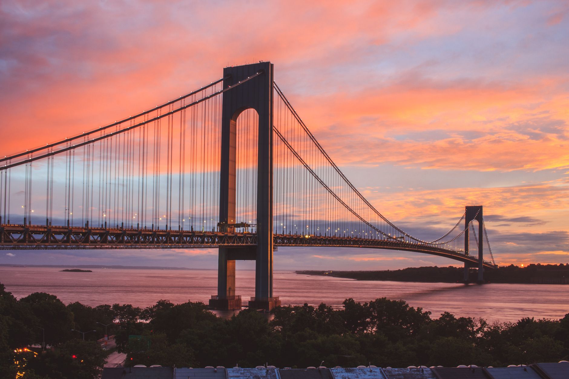 Stunning view of the Verrazzano-Narrows Bridge during a vibrant sunset in New York City.