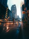 People Walking on Sidewalk Near High Rise Buildings