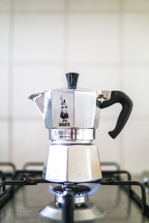 Retro geyser coffee maker placed on gas stove