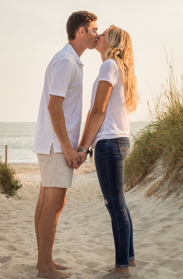 Romantic Young Couple Kissing On Sandy Beach