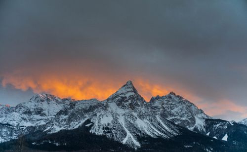 Free Stunning winter sunset over snowy mountains in Ehrwald, Austria with vivid orange glow. Stock Photo
