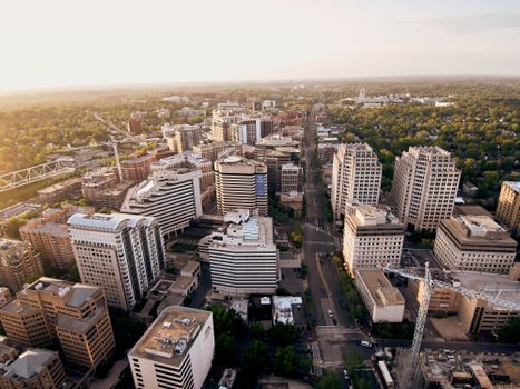 Drone view of street and modern buildings of new city district at sunset