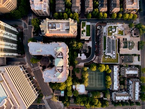 Drone top view of contemporary metropolis city complex with decent dwelling and public spaces amidst green trees