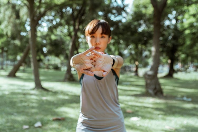 Ethnic Woman Doing Warm Up Exercise Before Training