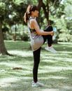 一名女子在阳光明媚的公园里热身