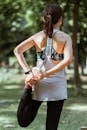 Fit sportswoman stretching legs in park