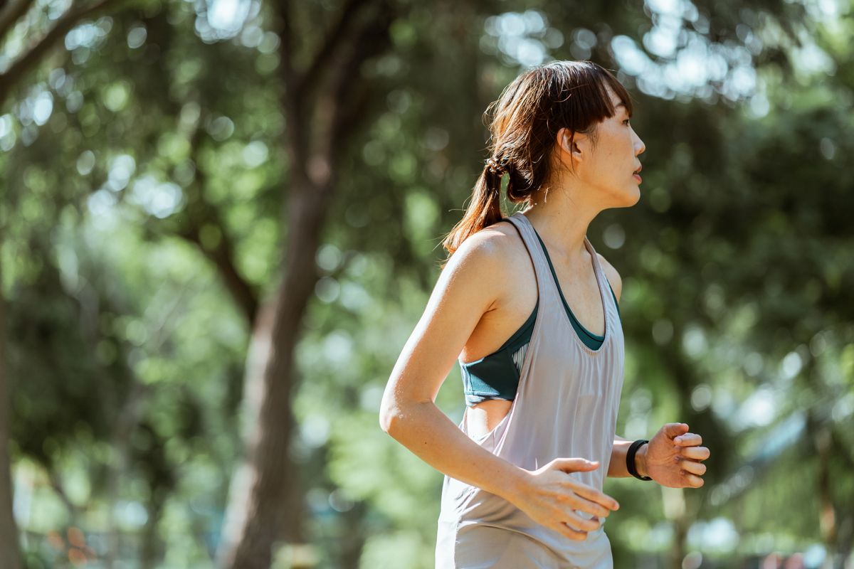 Focused female runner in sportswear on a path