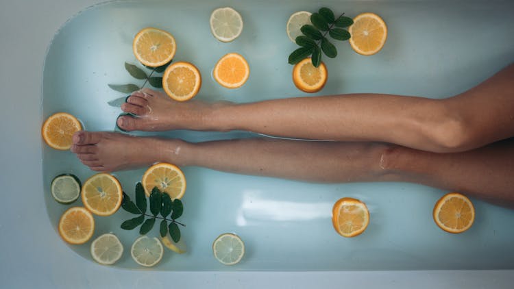 Person Holding Sliced Orange Fruit