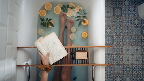 Free Person Holding Book Page on White Table Stock Photo