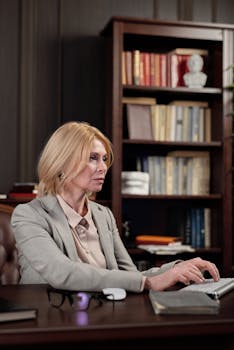 一位自信的女商人，在时尚的办公环境中，正于办公桌前工作