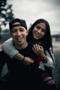 Man in Black Crew Neck Shirt Beside Woman in White Long Sleeve Shirt Smiling