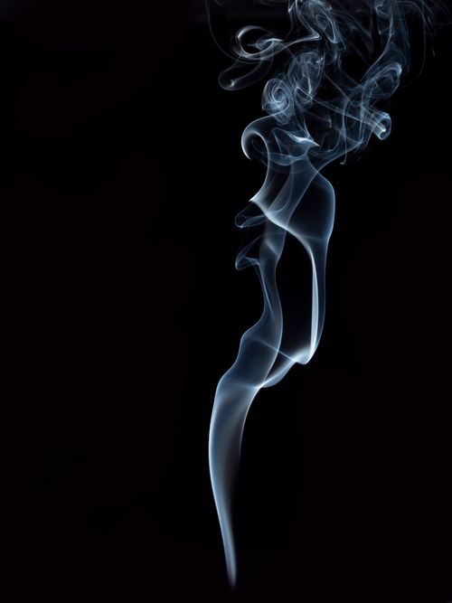 Free Artistic photograph of smoke trails against a black background, showcasing delicate swirling patterns. Stock Photo